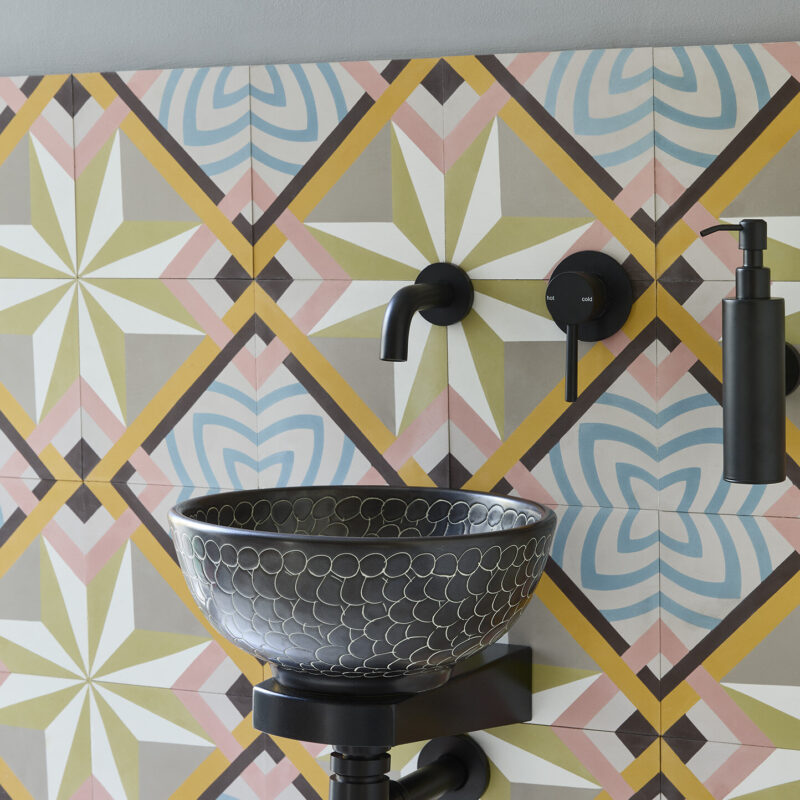 Mini Bryony basin paired with matt black Mini Finn support bracket, and wall-mounted black tap.