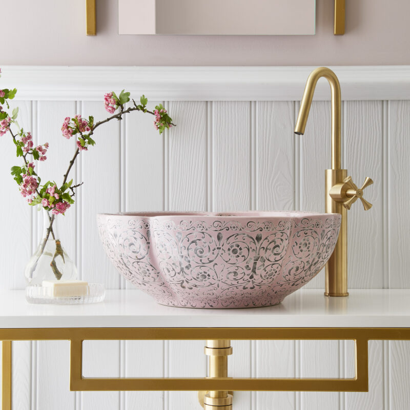 London Basin Company Amara basin on a white and gold vanity unit in front of white panelled wall with light pink wall above