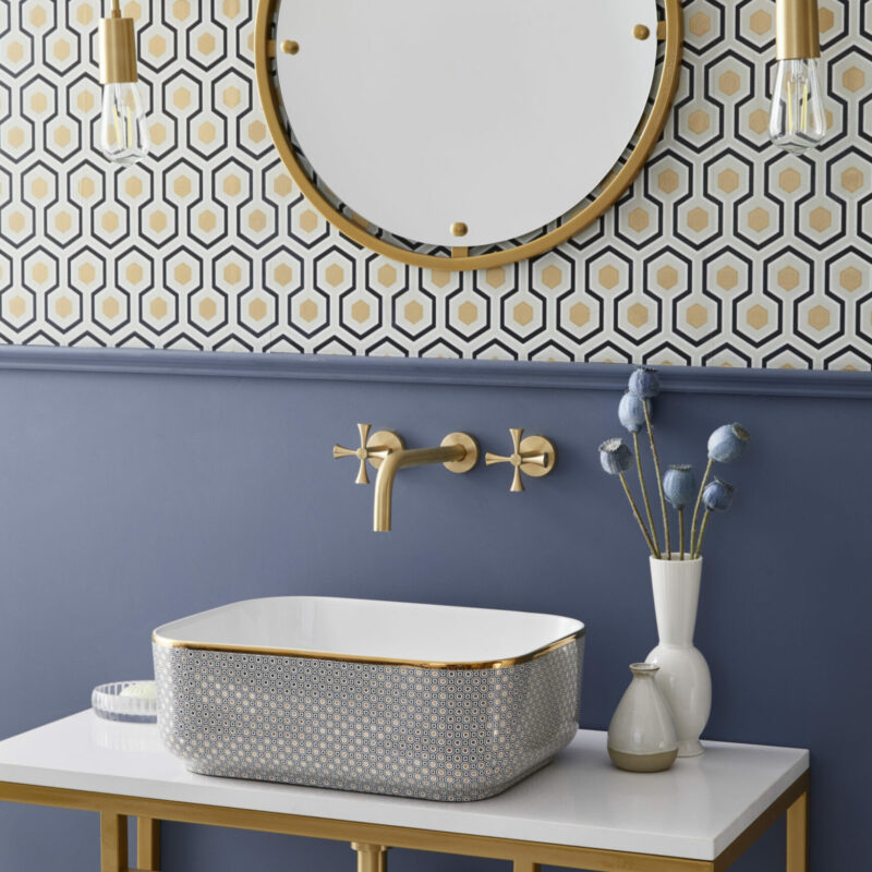 Designer bathroom sink with accents of gold in a modern stylish bathroom