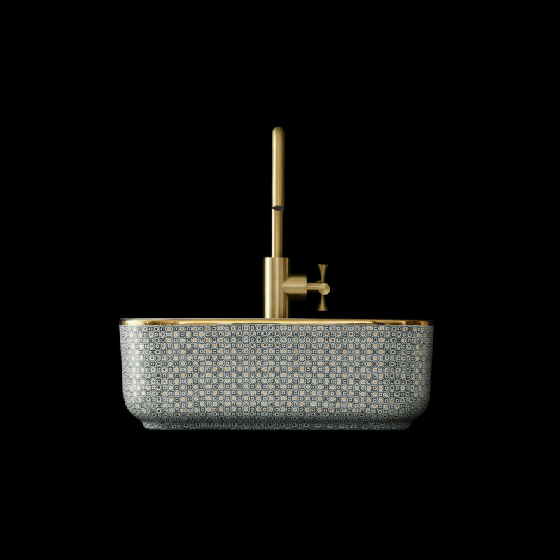 Designer art deco bathroom basin with a gold tap against a black background.