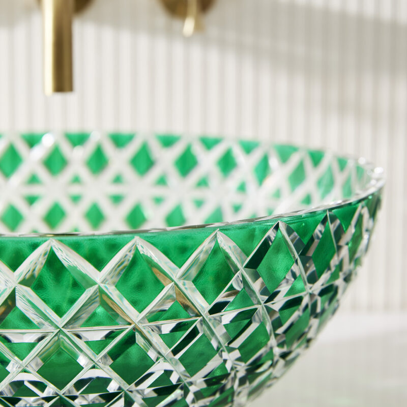 Close-up image of the Lucia basin in green glass with the Theo tap visible in the background.