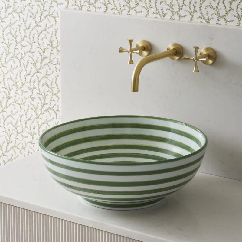 round striped countertop sage green basin made from the finest ceramic porcelain. Pictured with elegant wall-mounted brass tap