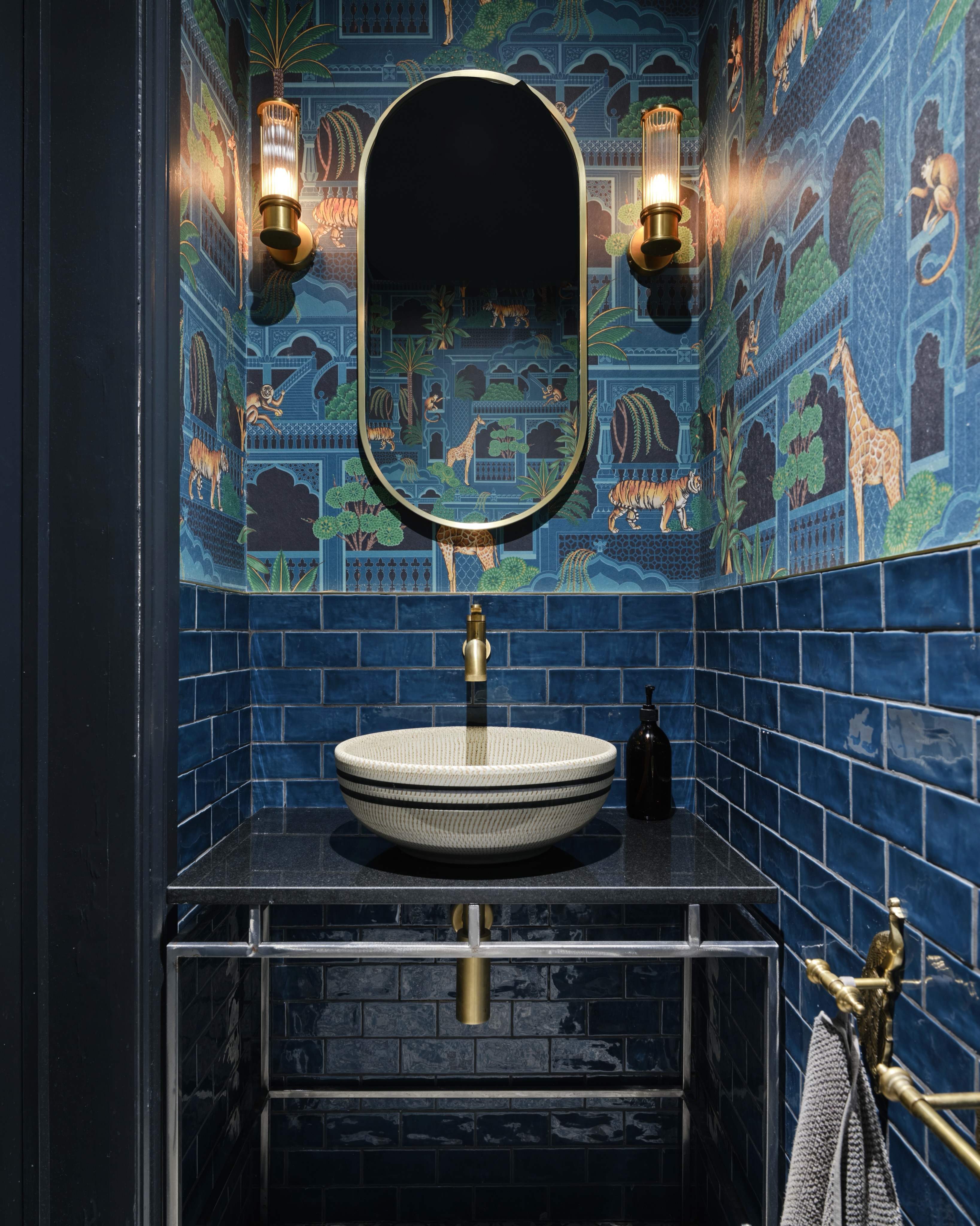 Designed by @dorisleestudio, this richly layered cloakroom combines deep blue tones, bold pattern...